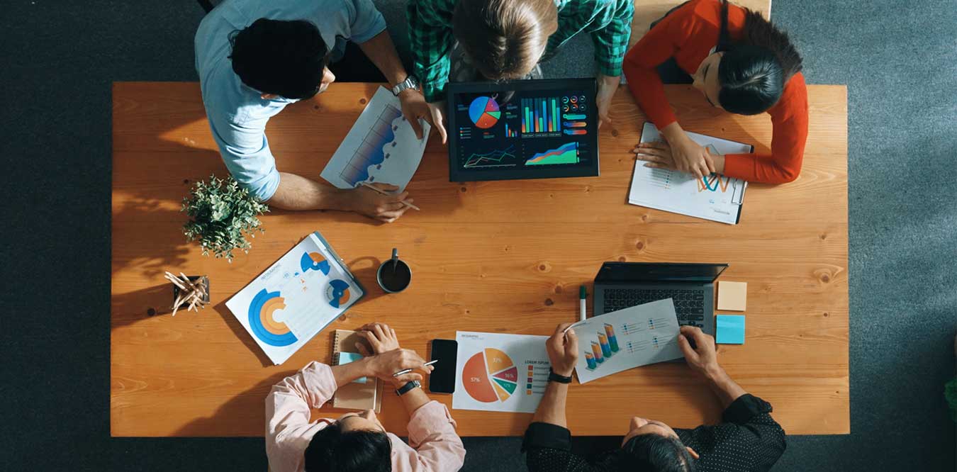 A group of directors sharing graphs and charts